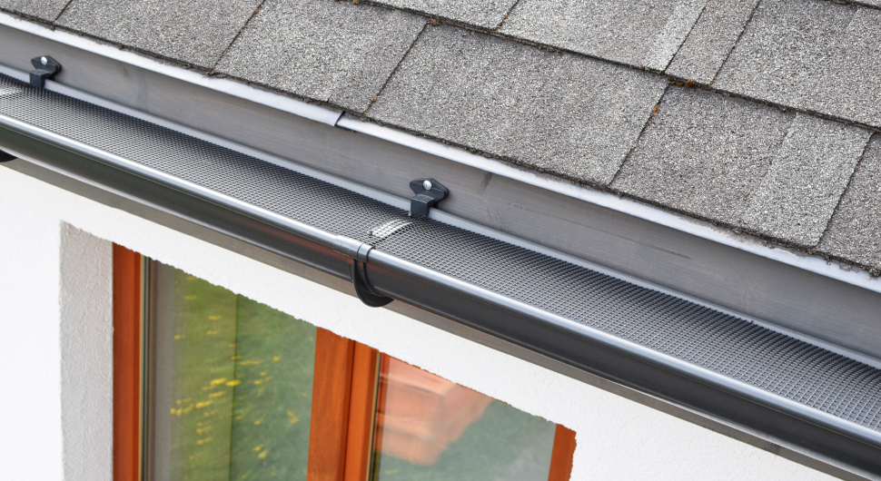 Wire mesh gutter guard on commercial building