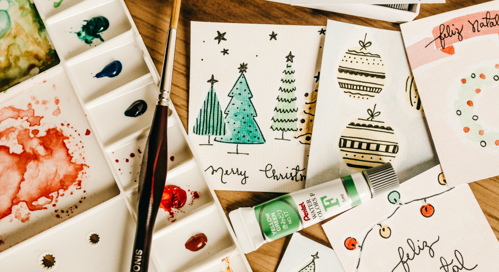 Crafting materials on top of a desk, which include craft paper, rulers, scissors, cards, and various other craft DIY tools.