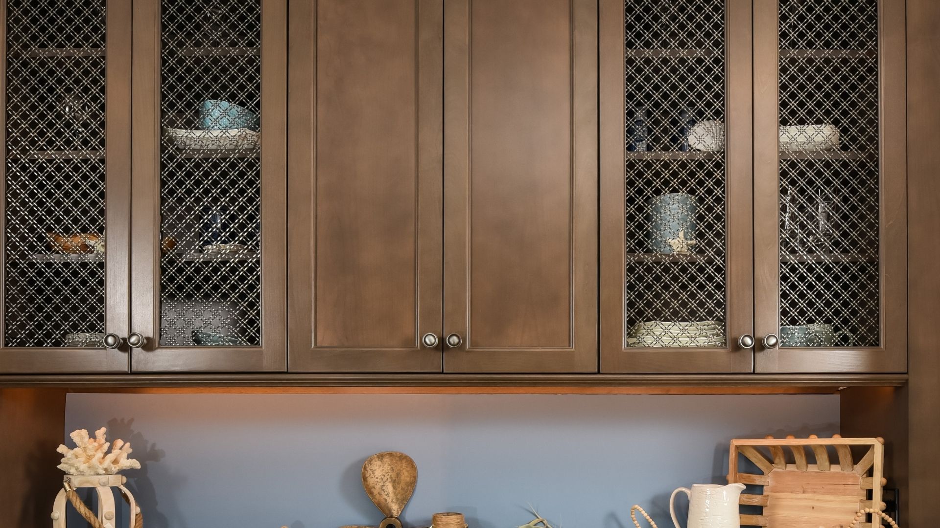 Brown cabinet with double diagonal weave stainless steel wire mesh inserts.