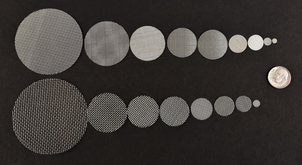 Wire mesh discs on black background.