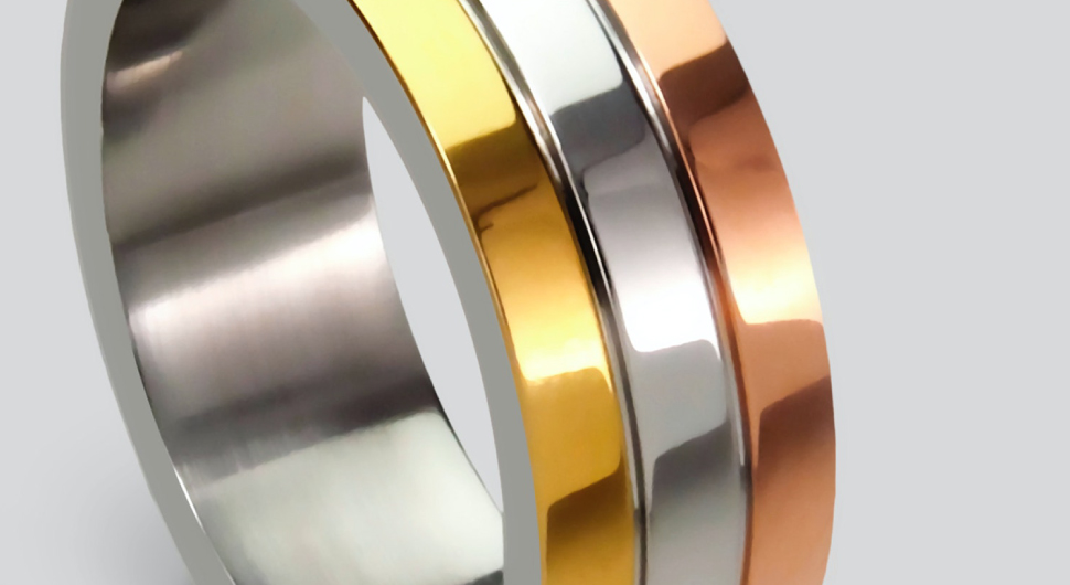 Three rings made of copper, gold, and silver.