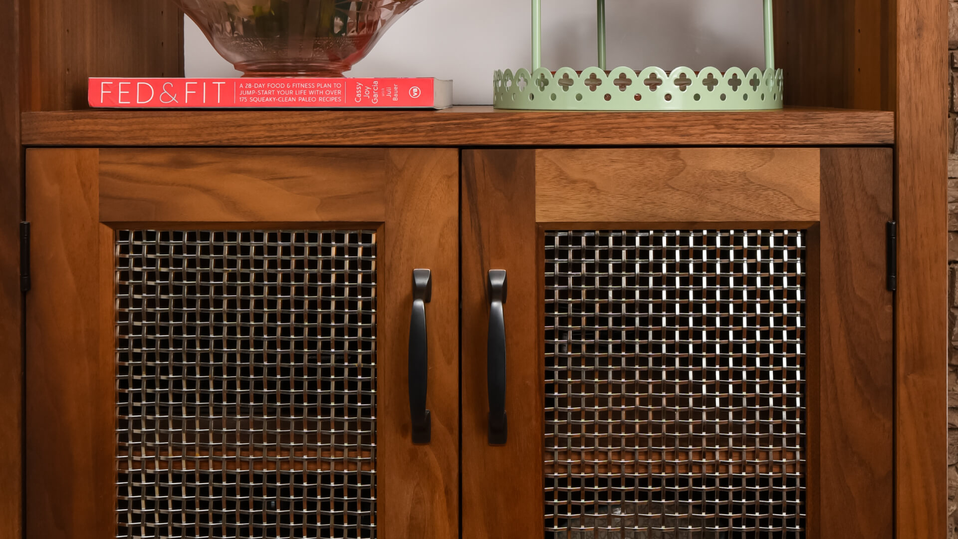 Woven wire mesh on the face of an armoire cabinet door.