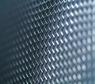 Close up of stainless steel wire mesh fence.