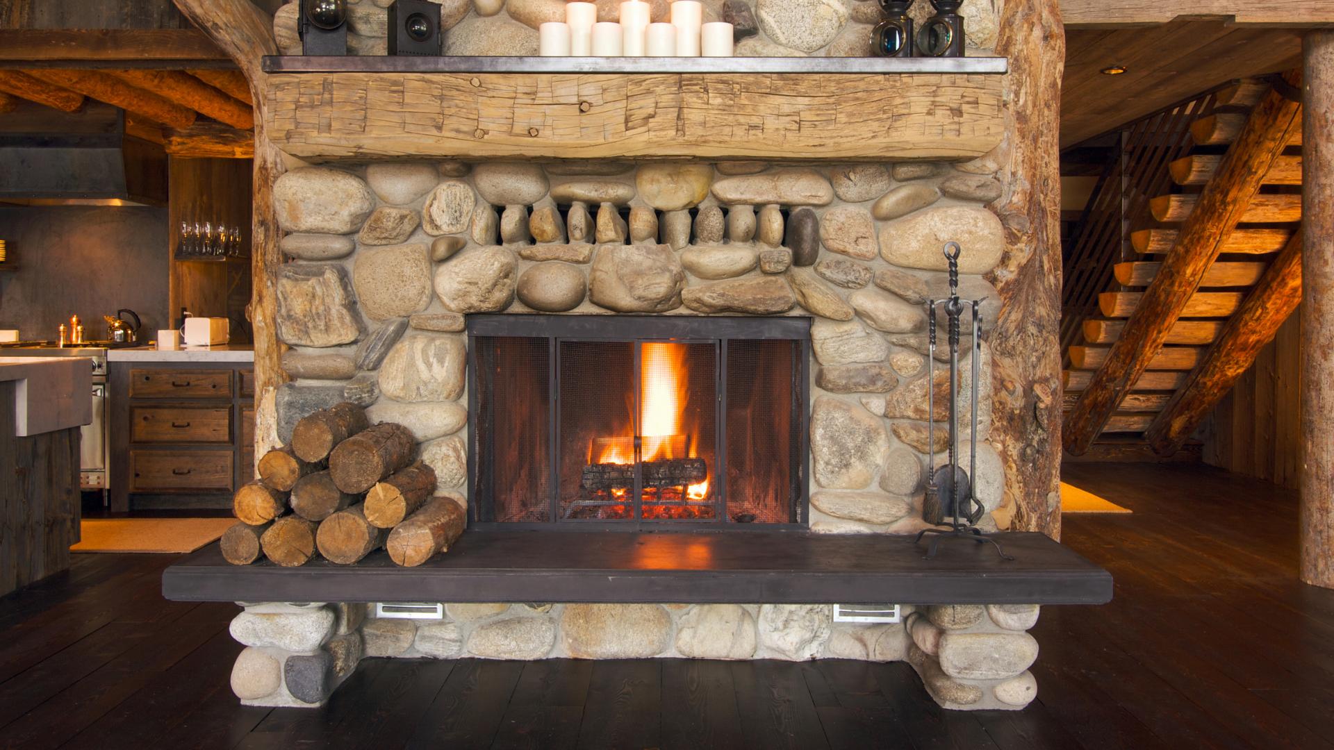 Large, elaborate stone fireplace with bench seating.