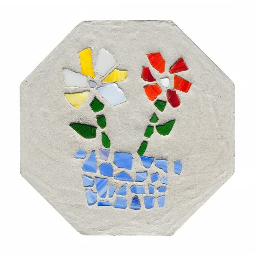 Octagonal concrete stepping stone with red, green, yellow, white, and blue pieces of glass in the shape of a flower.
