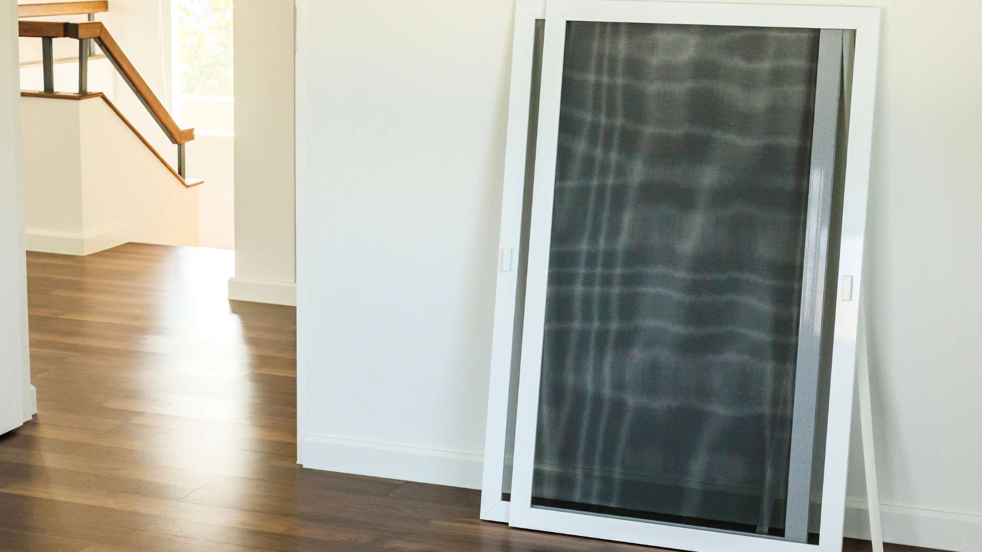 wire mesh screens leaning against hallway wall